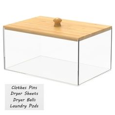 a clear plastic box with wooden lid for clothes pins and dryer sheets on the bottom