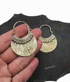 Beautiful crafted ethnic hoops with ridged design. With a round shape and a beautiful detail that will complement any look!  The aprox length of this piece s 4.9 cm and the aprox width 3.6 cm. Handcrafted with high quality hypoallergenic jewellery brass, nickel free. LINK Please follow the link to view my shop for other beautiful pieces. https://www.etsy.com/uk/shop/JagathaStudio Bohemian Festival, Hypoallergenic Jewelry, Earrings Bohemian, Ethnic Earrings, Boho Festival, Simple Earrings, Jewelry Earrings Hoops, Round Shape, Uk Shop