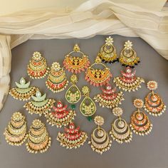 A pair of golden-toned Hand Painted Traditional Meenakari Earring for Saree.  Size & Other Details Material : Brass, Pearl, Meena work Shape : Flower Shaped Attire : Lehenga Choli, Salwar Suit, Kurti, Saree, Flared Dress FYI: Assorted designs will come depending on the stock available. 5 color left Shop more: https://www.etsy.com/shop/FashionCrabIndia/ Style Tip ---------------------------- Elevate your traditional outfits with our unique collection. Perfect for festivals. Care Tips ------------ Kundan Jewelry With Motifs For Navratri, Navratri Kundan Jewelry With Motifs, Traditional Chandbalis With Motifs For Festive, Festive Kundan Chandbalis With Motifs, Traditional Kundan Jhumkas With Motifs, Traditional Kundan Chandbalis With Motifs, Chandbali Motifs Jewelry For Diwali, Temple Jewelry Style Meenakari Chandbalis, Multicolor Cutdana Chandbali Bridal Earrings