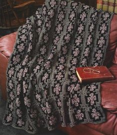 a blanket and book are sitting on a couch