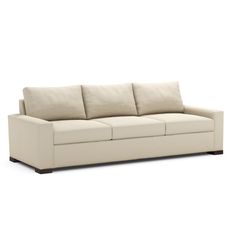 a white couch with three pillows on it