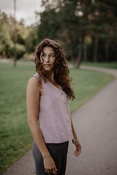 "Elegant yet fun linen top. Sleeveless, with a V neckline & seashell buttons. Perfect for every occasion - you can wear it to work, a picnic or even a night out! Choose from 15 colors and 6 sizes. * ABOUT This listing is for 1 TUNIS oversized V-neck top  with buttons Medium-weight linen (approx. 190 gsm) Made from 100% certified European linen (OEKO TEX certified) Stone washed for maximum softness Available in XS, S, M, L, XL, XXL Available in 15 colors * SIZES AND COLORS IN THE PICTURES Model Aistė is 177cm/5'8\" tall and she is wearing dusty rose TUNIS top in size S and MALMO pants in charcoal Please note that colors may vary due to different monitors and browsers. To ensure that you get the exact color you desire, we recommend ordering linen swatches: https://www.etsy.com/listing/922916 Spring Linen Beach Vest, Summer Beach Linen Vest, Linen V-neck Vest For Day Out, Summer Denim Vest With Buttons, Spring Linen Vest For Day Out, V-neck Linen Vest For Summer, V-neck Linen Summer Vest, Buttoned Sleeveless Blouse Tank Top For Summer, Buttoned Sleeveless Tank Top For Summer