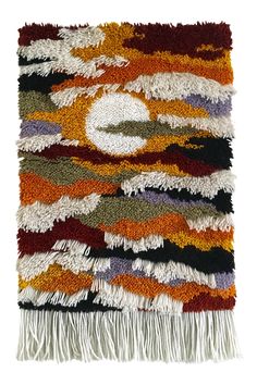 a multicolored rug with fringes on the bottom and an orange, black, white