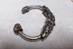 Very unique Bracelet, for a man or a woman,  it looks like a Dragon or Dragon Fish, very detailed Bracelet, It is not marked and should be,  and has been tested with silver acid on stone,  tested positive The top motif Dragon measures 3 1/4 inch long x 1/2 inch wide x 5/16 inch deep There are decorative detailed on the tips of each bracelet, design matching the dragon, as the dragon tails Measures 2 1/4 inch inside side to side,  very easy to slip on,  my wrist is a 6 inch so it should fit up to a size 7 wrist Solid Sterling 925 Weight 75.2 Grams 1960s Dragon Tails, Fish Bracelet, Dragon Fish, Dragon Tail, Fishing Bracelet, Unique Bracelets, Bracelet Design, A Dragon, The Dragon