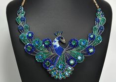 a blue and green peacock necklace on a mannequin