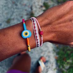 A small blue evil eye glass bead on a multicolor thread bracelet- Each item is handmade and unique, may have slight variations- This item is adjustable- Circumference of Bracelet: 6.25-9"- Width of Bead: 16 mm - Please allow 3-5 days for items to ship Pink Beaded Bracelet, Pink Beaded Bracelets, Thread Bracelet, Handmade Evil Eye, Glass Evil Eye, Shell Collection, Thread Bracelets, Kids Bracelets, Pink Beaded