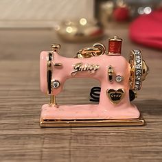 a pink toy sewing machine sitting on top of a wooden table