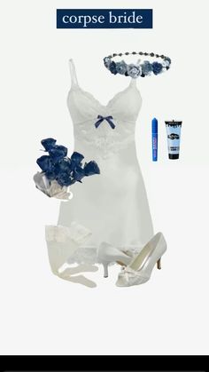 a woman's white dress and shoes with blue accessories