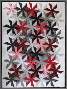 a quilt made with red and black stars