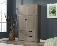 a bedroom scene with focus on the armoire and storage unit in the foreground