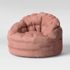 a pink bean bag chair sitting on top of a white floor