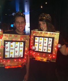 two people wearing crowns and holding up signs that read king of the slots, queen of the shots