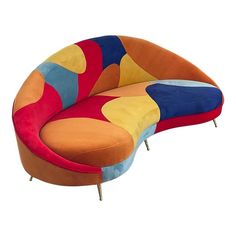 an orange, blue, yellow and red couch sitting on top of a white floor