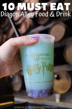 a person holding up a cup with the words wizard's food and drink on it