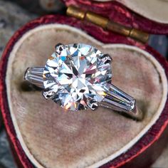 a diamond ring in a heart shaped box