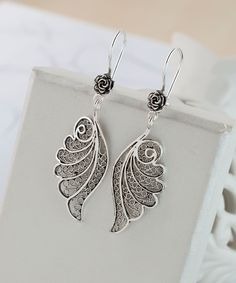 Angel Wing Dangle Earrings 925 Sterling Silver Wing Drop Earrings Artisan Handcrafted Filigree Floral Earrings Women Handmade Jewelry, Best Friend Gift, Bridesmaid Gift, vintage earrings, sparkly earrings Material: 925 Sterling Silver (NICKEL FREE) Length, Drop and Width: 5.5cm X 3.5cm X 1.6cm // 2.15 Inches X 0.6 Inches UPS - FREE, FAST AND TRACKABLE SHIPPING FOR ALL EU COUNTRIES AND USA. These earrings are so stunning and dainty. Perfect for everyday wear. They have a gorgeous small flower on the top of the earring and angel wing that hangs dainty. These earrings are made from our finest silver so they are durable for your everyday wear. COMES WİTH VELVET POUCH AND LUXURY GİFT BOX. Makes a great gift: Beautiful jewelry to give for every occasion. The perfect present  for mom , sister, da Filigree Jewelry Design, Unique Sterling Silver Earrings With Intricate Design, Sterling Silver Filigree Earrings As A Gift, Unique Sterling Silver Filigree Earrings, Ornate Silver Earrings With Ear Wire, Ornate Sterling Silver Earrings For Gift, Ornate Sterling Silver Earrings For Pierced Ears, Silver Earrings With Intricate Design As Gift, Silver Earrings With Intricate Design For Gift