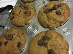 six chocolate chip muffins sitting in a pan on top of a stovetop