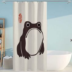 a bathroom with a bathtub and a shower curtain that has a frog on it