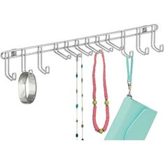 a metal rack with two rings and necklaces hanging from it's sides next to a pair of jewelry