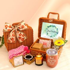 a wicker basket filled with lots of goodies next to a card and candle