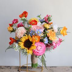 a vase filled with colorful flowers on top of a table