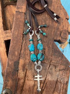 Beautiful blue Hubei Turquoise stones highlighted by Fine Hill Tribe silver beads in lovely Navajo design. The pendant is a sterling silver double cross with a sweet heart. I've strung this on subtle deep brown leather with tails of Fine Hill Tribe silver and Hubei beads. There is a sterling silver slide bead for which you can adjust this necklace to a choker style if preferred. Life is too short to wear boring jewelry! Bohemian Cross Pendant Jewelry, Bohemian Turquoise Cross Pendant Necklace, Southwestern Necklace, Hill Tribe Silver, Choker Style, Turquoise Stone, Silver Beads, Brown Leather, Turquoise Necklace