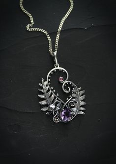 ITEM DESCRIPTION: The size H 4 cm x W 3 cm (1 2/3 x 1 inch). Weight - 5 g. You can buy it with a silver chain or without. I made this amazing Fern necklace of sterling silver, natural amethyst, and rhodolite garnet. This is a real piece of the mysterious woodland: fern leaves, grass, and mushrooms. Perfect botanical pendant for nature lovers! From my childhood, I have heard a Ukrainian legend about blooming ferns. Anyone who finds a flower of ferns during the shortest night will have happiness, Ursula Jewelry, Copper Wire Crafts, Fern Necklace, Forest Necklace, Necklace Amethyst, Fern Leaf, Leaf Pendant, Wrapped Pendant, Wire Wrapped Pendant