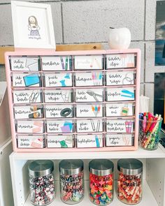 a shelf filled with lots of different types of crafting supplies on top of it