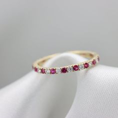 Luxurious alternating Gemstones ringFeaturing Rubies & White Sapphires in an open deck Eternity style ring.Natural Gemstones, hand picked for best color and clarity.Open sided style setting to allow more light and create more sparkle with an Elegant finish.The Gemstones are 1.75mm in DiameterFor Example a Size 7 will have 30 stones and about 0.6 CtwEach ring is perfect in its own way.All item custom made to your specifications by Ardonn.items are Shipped with FedEx/Ups fully insured and trac Ruby Half Eternity Round Ring In Fine Jewelry Style, Ruby Rings With Half Eternity Round Band, Ruby Half Eternity Ring With Round Band, Half Eternity Ruby Rings, Fine Jewelry Ruby Eternity Band Round Cut, Fine Jewelry Ruby Ring With Half Eternity Band, Ruby Half Eternity Ring With Diamond In Round Band, Ruby Diamond Ring With Half Eternity Round Band, Ruby Round Cut Eternity Band