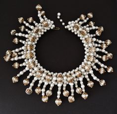 "This incredible collar necklace is unsigned, however, it is attributed to either Coppola e Toppo, Mimi D'N, or Hattie Carnegie. Whoever the designer, it is fabulous and done with incredible talent, artistry, and quality construction Look at the back side constructiongorgeous glass pearl bead strings are mounted onto a weft (like Coppola e Toppo) of glass pearls. The strings are made up of glass pearls, rhinestone rondelles, and rhinestone rondelle balls. There is some color wear to the gold pla White Necklace With 17 Jewels For Celebration, Traditional White Jewelry For Evening, Traditional White Evening Jewelry, Luxury Beaded Bridal Necklace For Wedding, White Round Bridal Necklace For Evening, Celebration White Bridal Necklace With 17 Jewels, Glamorous White Necklaces For Evening, Glamorous White Bridal Necklace Gift, White Beaded Bridal Necklace For Evening