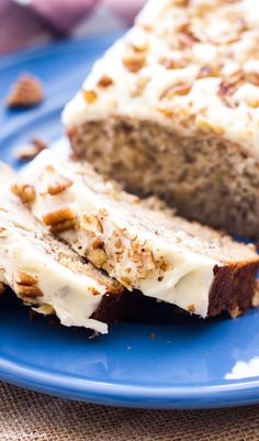 a loaf of banana nut bread on a blue plate with walnuts around the edges