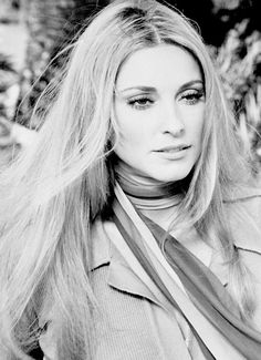 black and white photo of woman with long blonde hair wearing a scarf around her neck