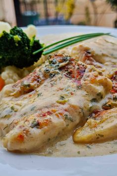 a white plate topped with chicken covered in gravy