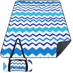 a blue and white chevroned blanket with duffle bag next to it on a white background