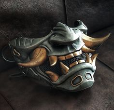 Oni cyberpunk half mask. This is an original Oni mask created by the Maskitto team. The height of the mask (with fangs) is 155 mm, the width is 205 mm. depth 125 mm. The mask fits perfectly on an adult's head and has holes for a strap.The mask is hand painted.