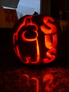 a pumpkin carved to look like it has the letter d on it's face