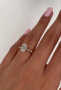 a woman's hand with a diamond ring on it