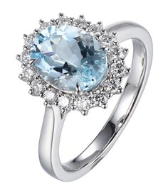 an oval blue topazte and diamond ring with white diamonds on the sides, set in