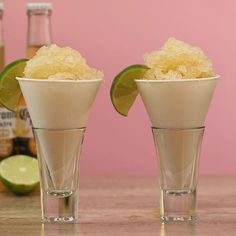 two shot glasses filled with sugar and limes