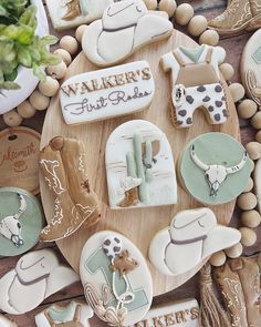 decorated cookies are arranged on a wooden platter with the words walker's first ride