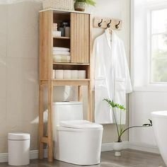 This over the toilet storage cabinet features a unique corrugated recessed panel with blister molding technology that adds texture and a sense of space, creating an extraordinary piece for your space. With white faux marble countertop with melamine veneer, delicate texture. With smooth curved edges and wide metal handles, it has both classic and modern charm.Maximize the size of your organization with our multifunctional cabinets. With adjustable shelves, sliding doors and a semi-open bottom com Over The Toilet Storage Cabinet, Toilet Storage Cabinet, Faux Marble Countertop, Over Toilet Storage, Over The Toilet Storage, Over The Toilet Cabinet, Bathroom Space Saver, Freestanding Bathroom Cabinet, Over The Toilet