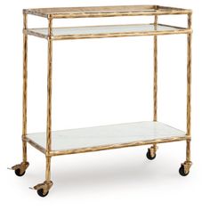 a gold metal and glass bar cart with two shelves on casteors, one shelf is empty