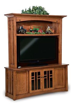 a wooden entertainment center with a flat screen tv on it's sides and shelves