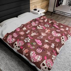 a bed with a brown and pink blanket on top of it