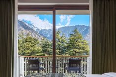 a hotel room with a balcony overlooking the mountains