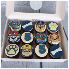 a box filled with cupcakes decorated like paw patrol characters