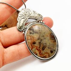 "Crazy lace agate necklace sterling silver large oval lace agate pendant orange brown beige antique bohemian style, artisan boho jewelry A beautiful large oval crazy lace agate stone with hues of brown, beige and orange in sterling silver statement pendant. Lovely autumn colors and winter colors too. The stone is set inside a bezel and framed with braided wire . On top of it there is an engraved antique floral pattern. I have oxidized it to bring out the details and achieved this bohemian look T Bohemian Jewelry With Oval Pendant Natural Stones, Bohemian Brown Necklace With Large Stone, Bohemian Necklaces With Large Oval Pendant Stone, Bohemian Necklace With Large Oval Pendant Stone, Bohemian Oval Agate Necklace, Bohemian Silver Necklace With Large Stone, Silver Oval Bohemian Necklaces, Bohemian Sterling Silver Oval Pendant Necklace, Bohemian Nickel Free Oval Pendant Necklace