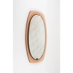 an oval mirror mounted on the wall