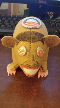 a stuffed animal head sitting on top of a wooden desk