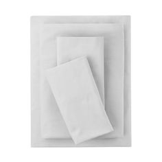 two white napkins on top of each other in front of a white background with one folded